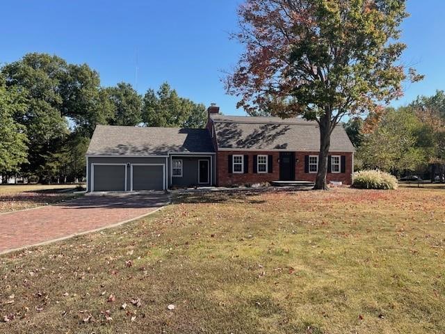 view of front facade with a front yard and a garage