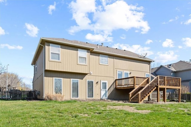 back of house with a yard and a deck