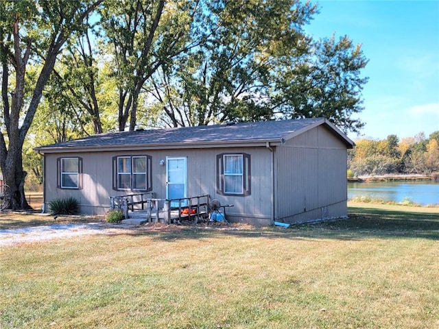 view of front of house with a water view and a front yard