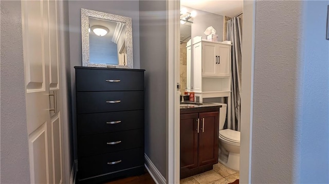 bathroom with tile patterned floors, vanity, and toilet