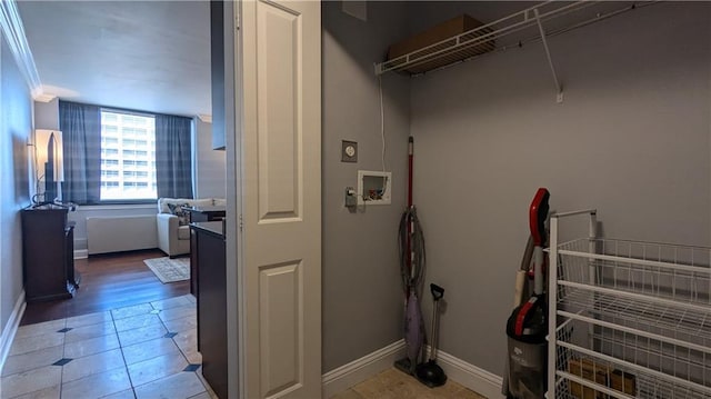 washroom featuring washer hookup, ornamental molding, and hardwood / wood-style floors