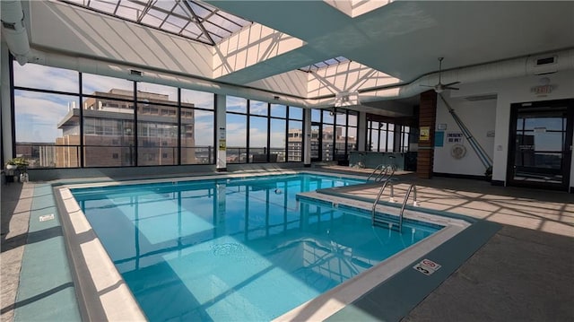 view of pool with a skylight and ceiling fan