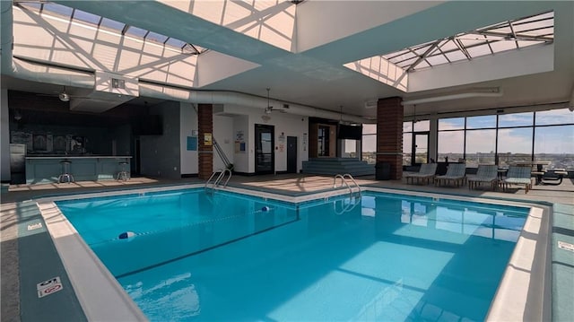 view of pool featuring a skylight and ceiling fan