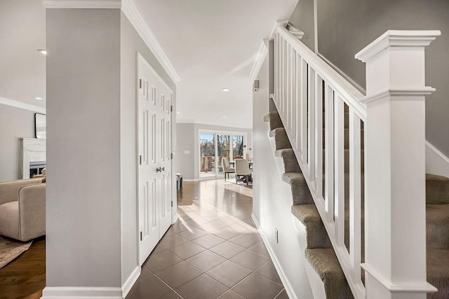 interior space with recessed lighting, baseboards, ornamental molding, and tile patterned flooring