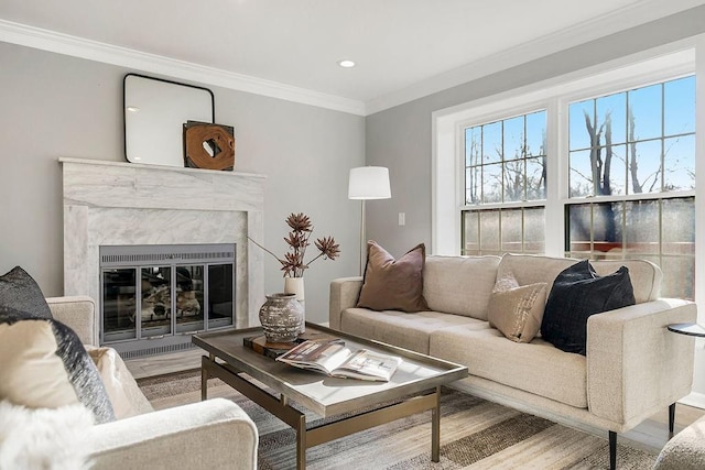 living room featuring crown molding, recessed lighting, wood finished floors, and a high end fireplace