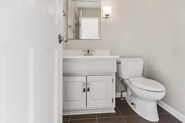 bathroom with tile patterned floors, baseboards, toilet, and vanity