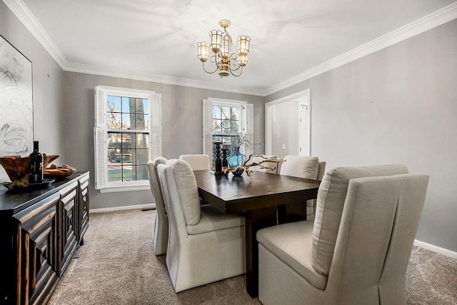 carpeted dining space featuring an inviting chandelier, baseboards, and ornamental molding