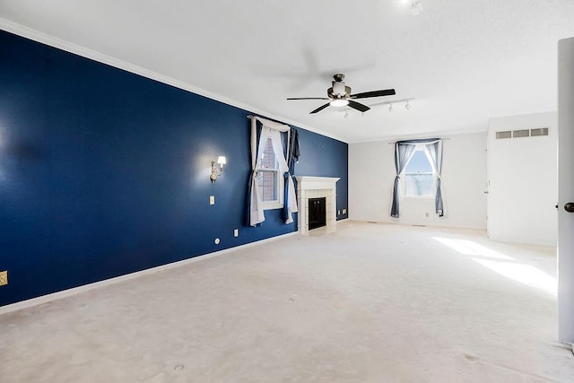 unfurnished living room with visible vents, baseboards, ornamental molding, a fireplace, and a ceiling fan