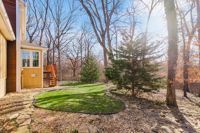 view of yard with stairs and fence