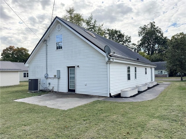 back of house featuring a patio, a lawn, and central AC