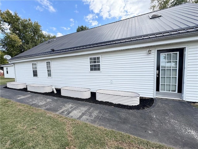 view of property exterior featuring a lawn