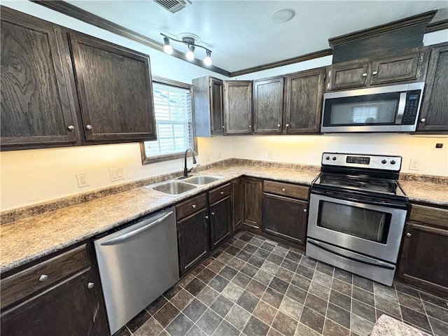 kitchen with ornamental molding, appliances with stainless steel finishes, sink, and dark brown cabinetry