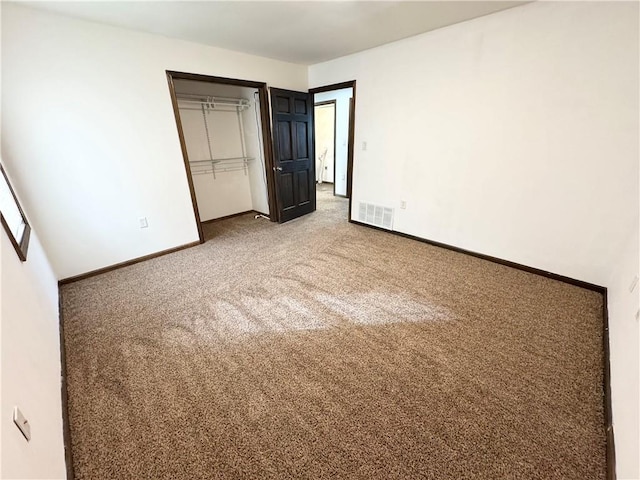 unfurnished bedroom with carpet floors and a closet