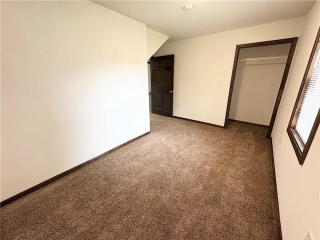 unfurnished bedroom featuring carpet floors and a closet