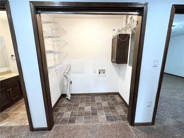 clothes washing area with dark carpet and washer hookup