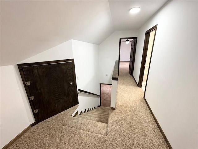 hall with carpet floors and lofted ceiling