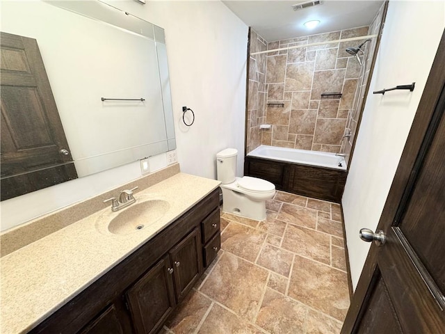 full bathroom featuring vanity, toilet, and tiled shower / bath