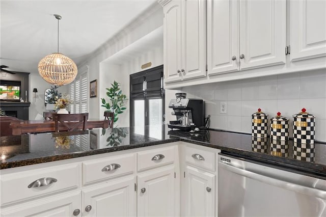 kitchen with dishwasher, dark stone counters, white cabinets, and decorative light fixtures