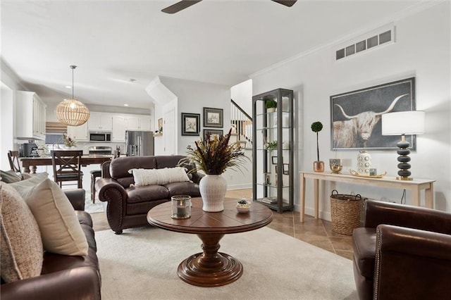 living room featuring light tile patterned flooring and ornamental molding