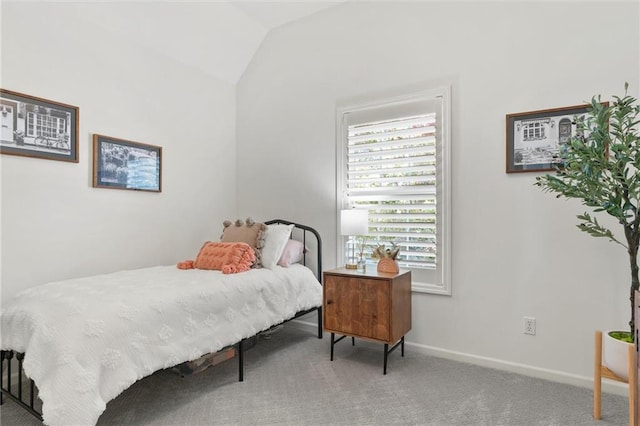 carpeted bedroom featuring lofted ceiling