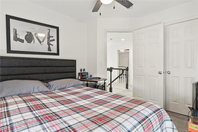 bedroom with ceiling fan, light colored carpet, and a closet