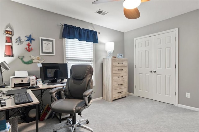 home office with ceiling fan and light carpet