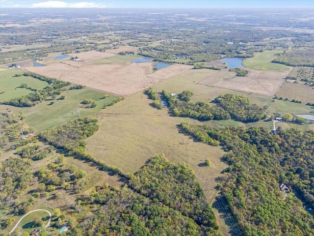 birds eye view of property featuring a rural view and a water view