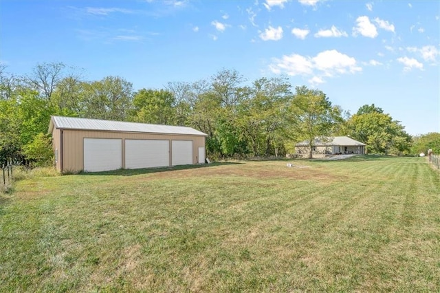 view of yard featuring a garage and an outdoor structure