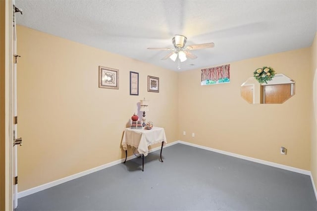 interior space with concrete floors, a textured ceiling, and ceiling fan