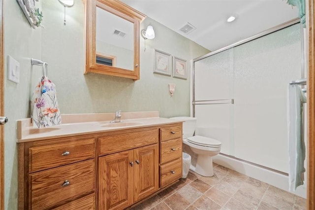 bathroom featuring walk in shower, vanity, and toilet