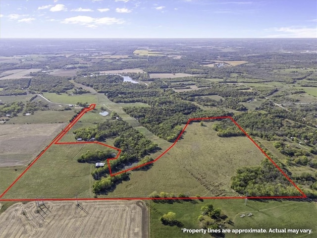 birds eye view of property with a rural view