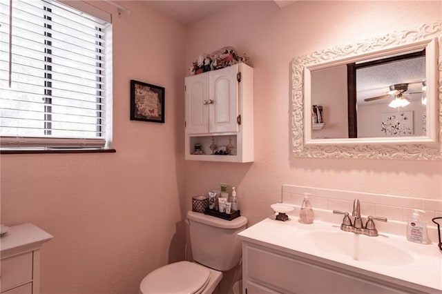 bathroom featuring ceiling fan, toilet, and vanity