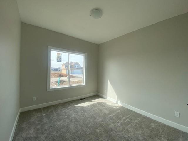 carpeted empty room with baseboards