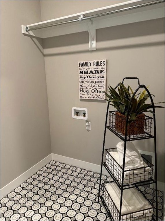 laundry room featuring laundry area, hookup for a washing machine, and baseboards