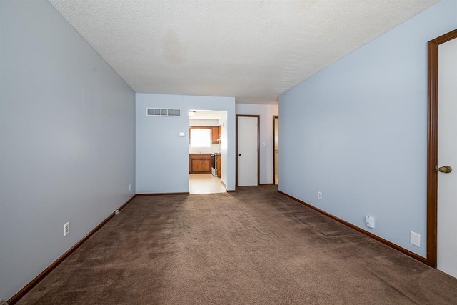 carpeted spare room with a textured ceiling