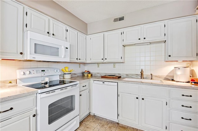 kitchen with white cabinetry, sink, and white appliances