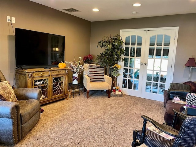 sitting room featuring carpet flooring and french doors