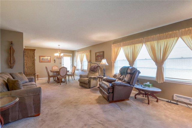 carpeted living room featuring a healthy amount of sunlight and an inviting chandelier