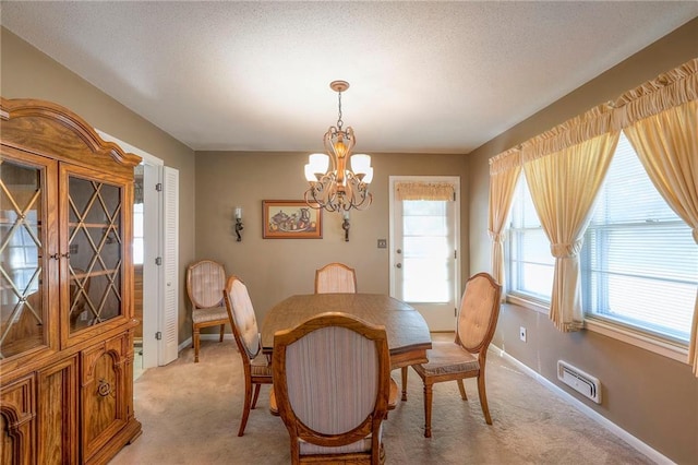 dining area with light carpet and a notable chandelier