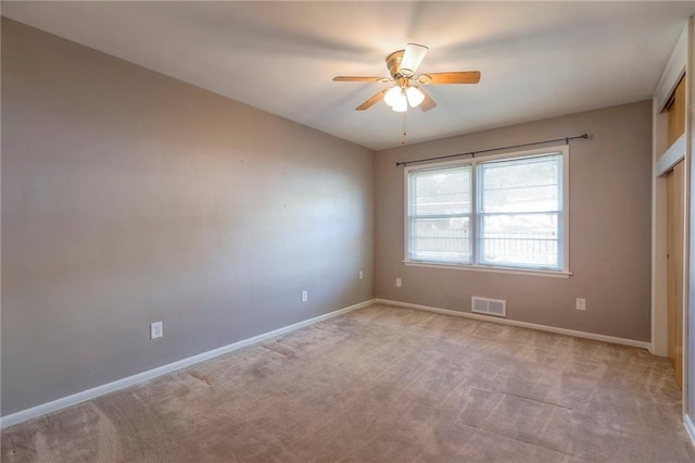 carpeted empty room with ceiling fan