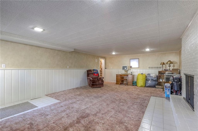 basement featuring carpet flooring and a fireplace