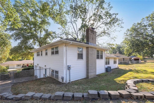 view of home's exterior featuring central AC and a lawn