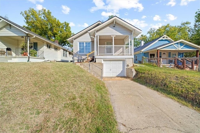 view of front of house with a garage, a front lawn, and a porch