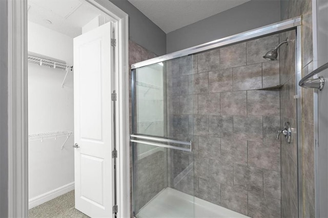1101 Walnut St Unit 605, Kansas City, MO 64106 - bathroom featuring a shower stall and a walk in closet