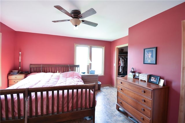 bedroom featuring a closet, ceiling fan, and a spacious closet