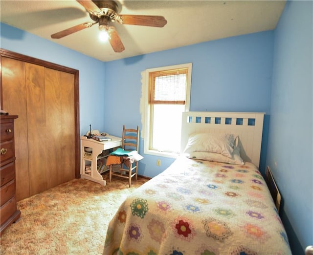 carpeted bedroom with a closet and ceiling fan