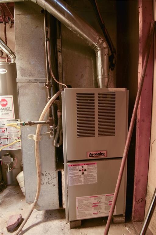 utility room featuring gas water heater