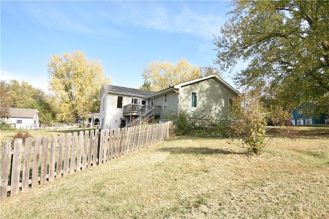 exterior space with a deck and a lawn