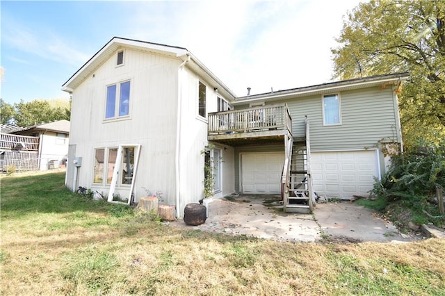 rear view of house with a yard and a garage