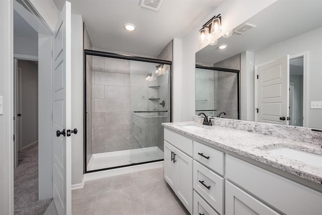 bathroom featuring tile patterned floors, vanity, and walk in shower